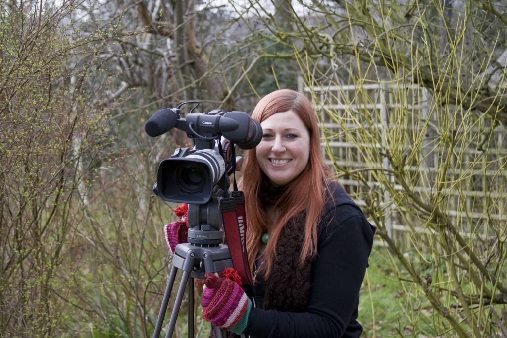 Laura with camera in a wildlife garden