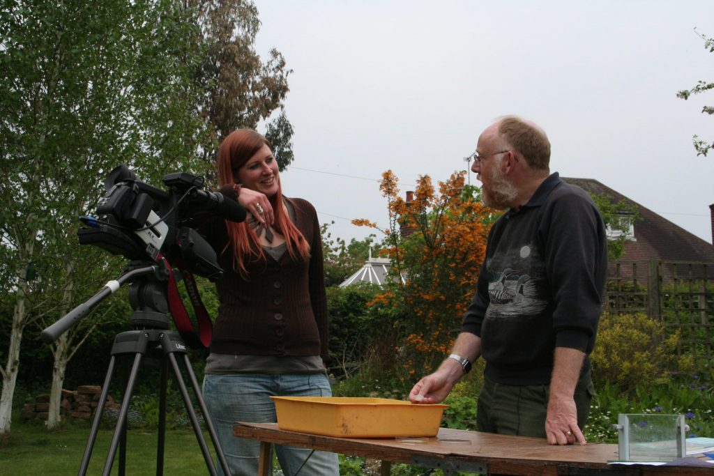 Laura and David with camera in a wildlife garden
