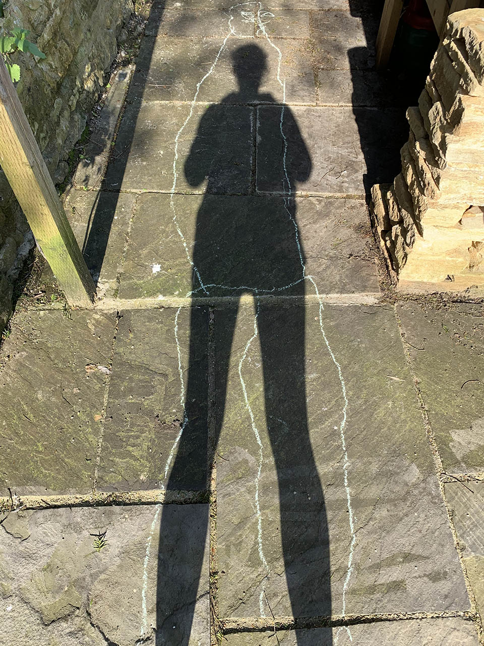 A shadow on the ground with an outline around it
