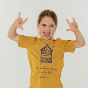 A girl wearing a yellow t-shirt with a bug hotel on