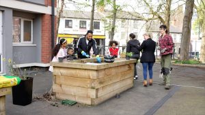 Residents at Byron Court in Nottingham around a planter